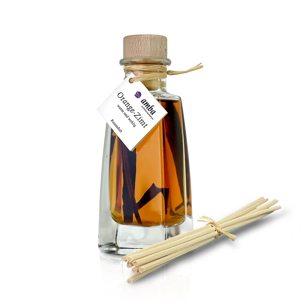 Orange Zimt mit Zimtstangen_Glasflasche mit Korken 100ml und Stäbchen liegen neben der Flasche