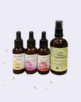 vier Glasflaschen mit Pipette_3 Gesichtsöle a 30ml_Pur_Rosengarten_Honeymoon_und Hydrolat 100ml_Mix aus Melisse_Kamille_Rose